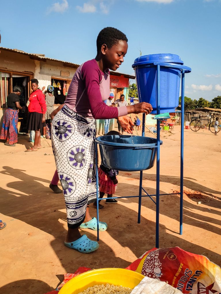 Woman washing hands at the market